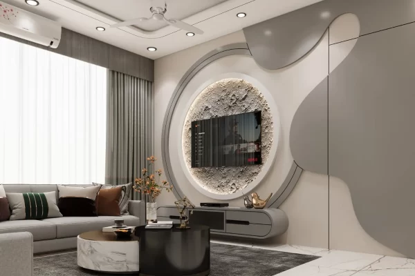 Living room of a 5 BHK villa in Vashi, Navi Mumbai - curved TV feature wall with a circular mirror and grey sectional sofa