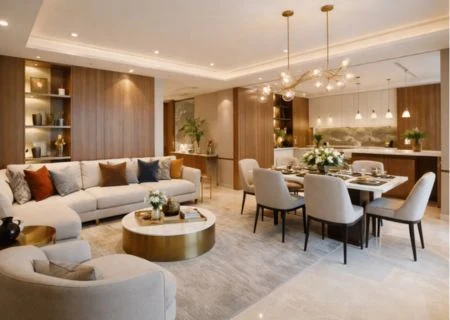 Luxury living and dining room with a curved sofa, statement chandelier and a round dining table